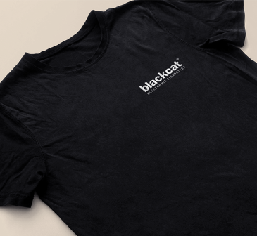 A black t - shirt with a white logo on it.