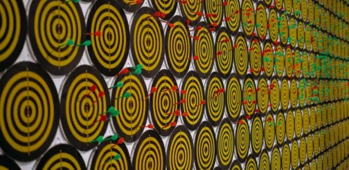 A wall of yellow and black circles on a wall.