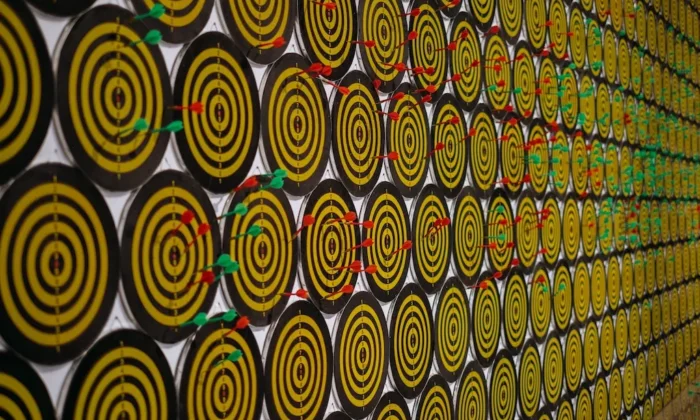 A wall of yellow and black circles on a wall.